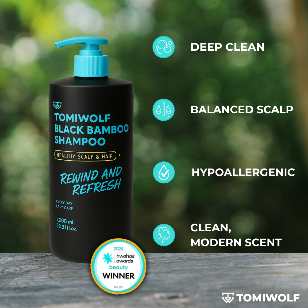 Tomiwolf Black Bamboo Daily Refreshing Shampoo in a 1000ml black bottle with a blue pump on a wooden surface.